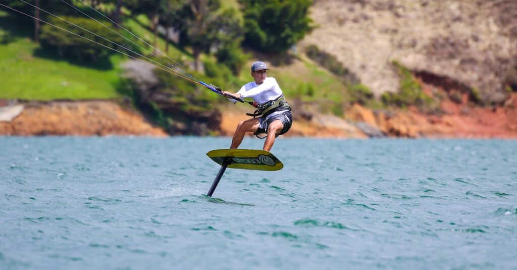 Exciting kiteboarding scene over turquoise water capturing action and thrill on a sunny day.