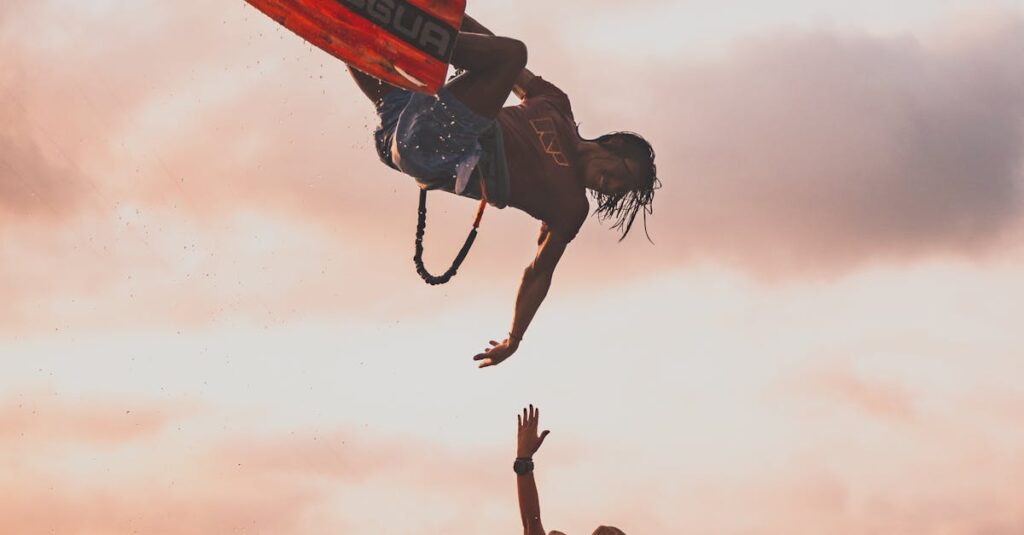 Silhouette of a man and woman kitesurfing at sunset, capturing the thrill of water sports.